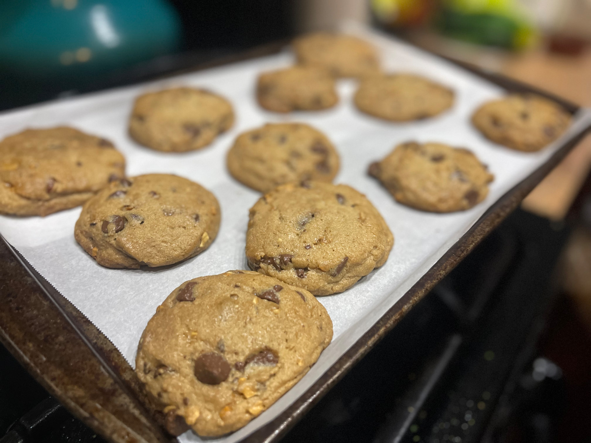 Cookies cooling on a parchment-lined baking sheet